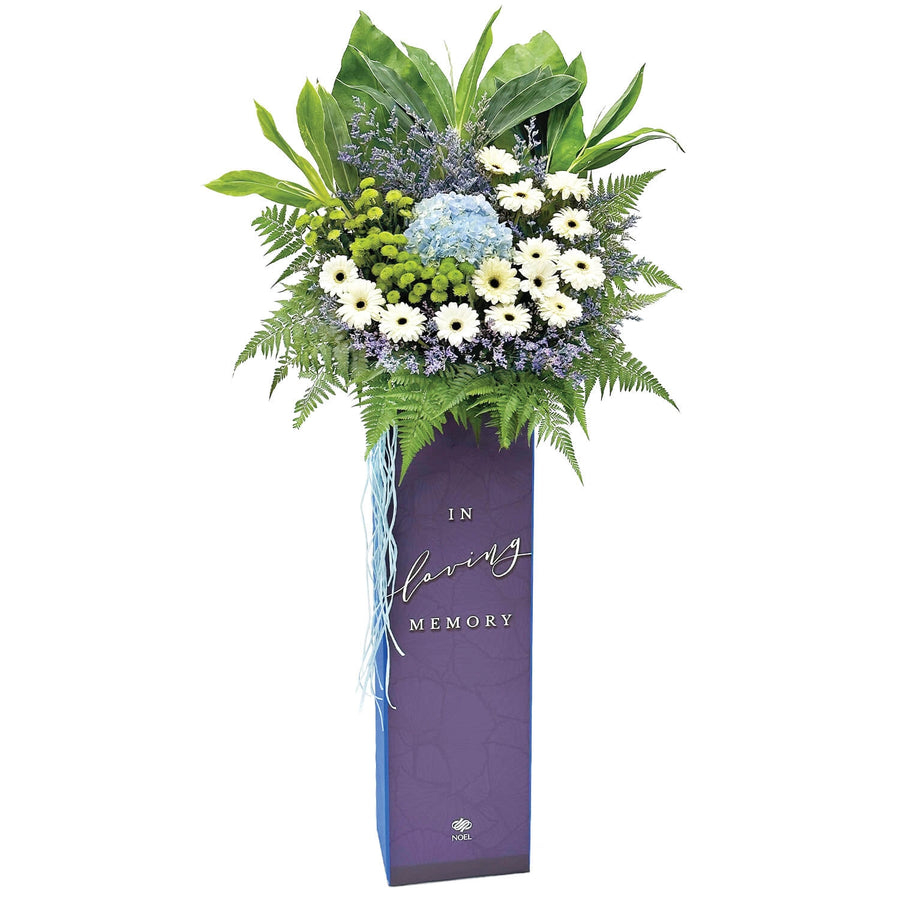 Loving Memory condolence flower arrangement with white flowers, blue hydrangea and greenery