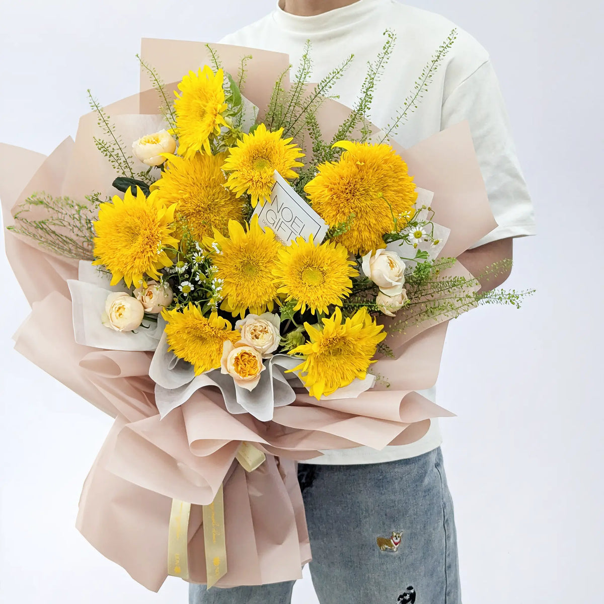 Man holding Sunshine Hugs Classic Hand Bouquet with Teddy Bear Sunflowers