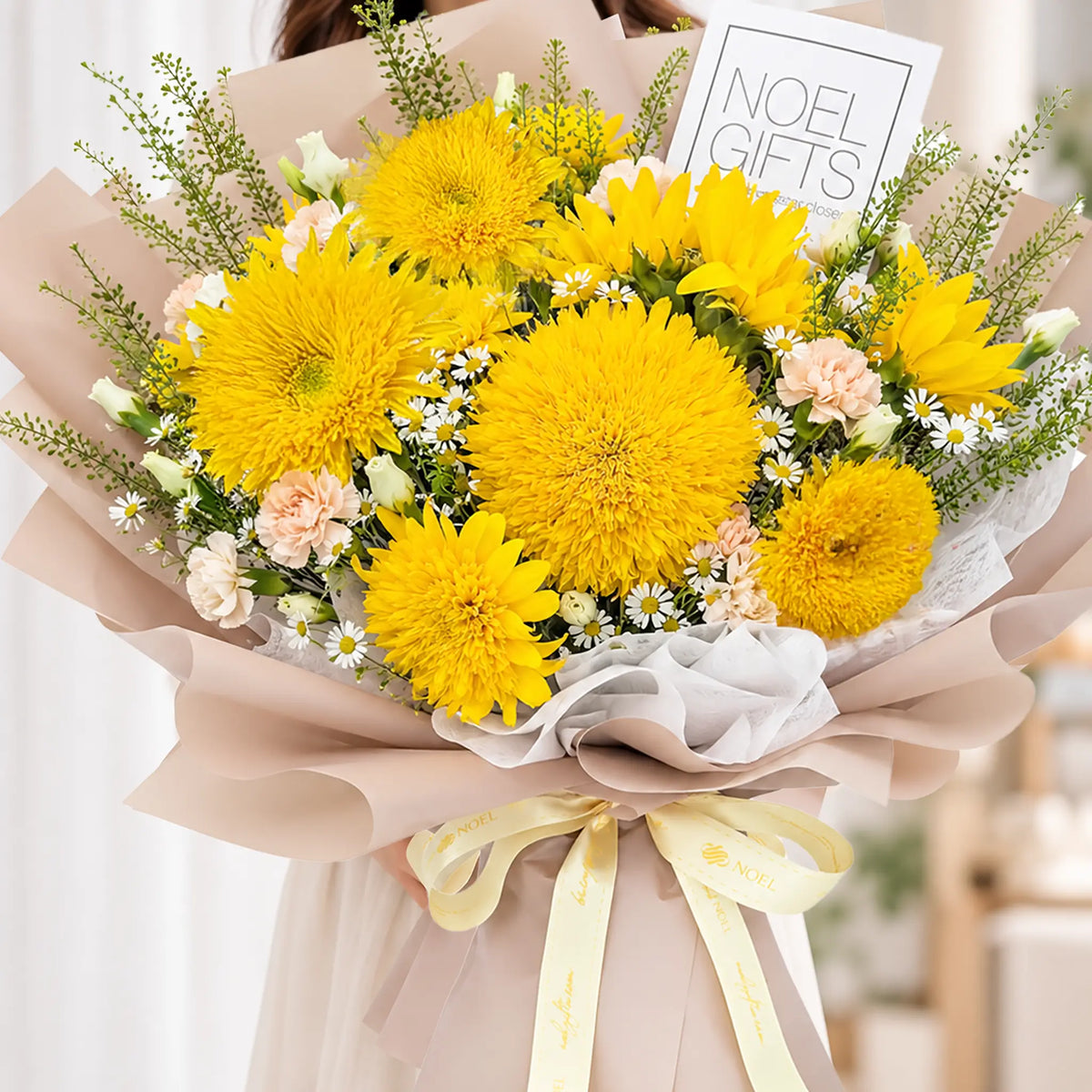Woman receiving Sunshine Hugs Deluxe Hand Bouquet with Teddy Bear Sunflowers