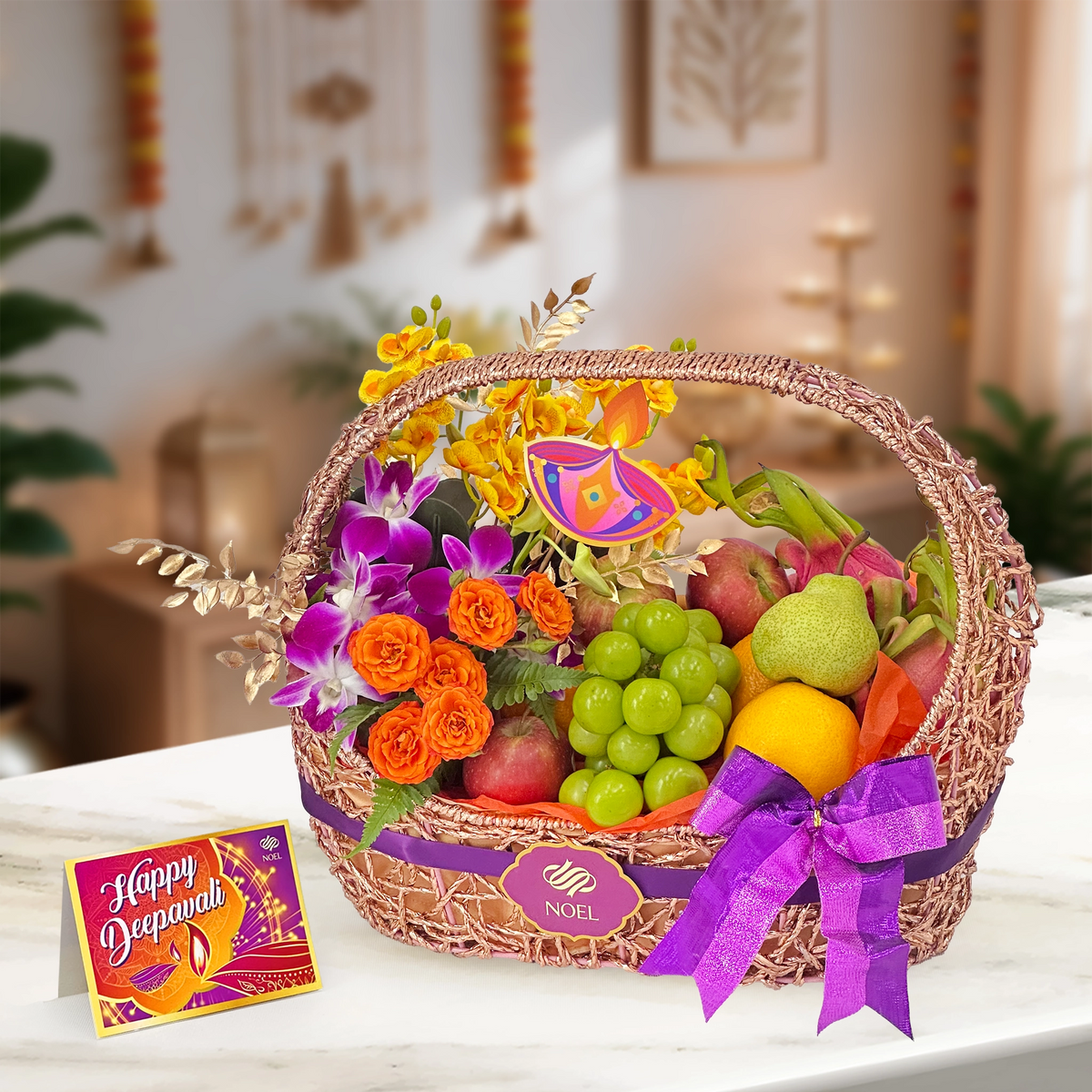 Deepavali Harvest Blessings Fruit Basket with fresh seasonal fruits, yellow orchids, orange roses and lush greenery