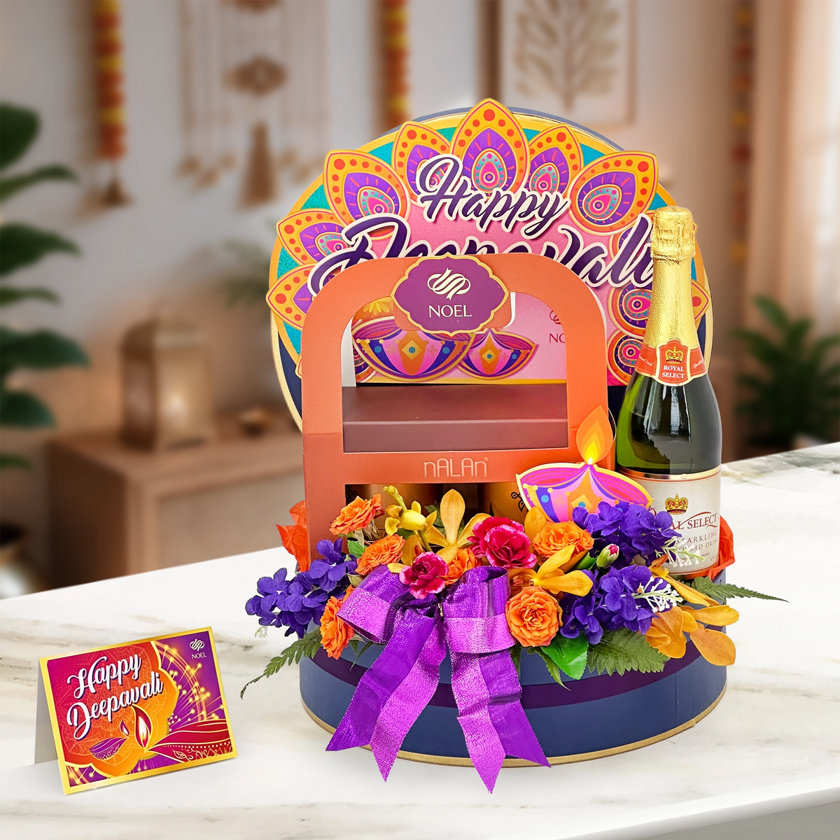 Deepavali Blooming Wishes Gift Hamper with sparkling juice, traditional savouries and fresh orange roses and maroon carnations