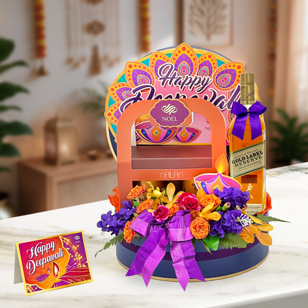 Deepavali Golden Blossoms Gift Hamper with Johnnie Walker Gold Label Reserve, traditional savouries and fresh orange roses and maroon carnations