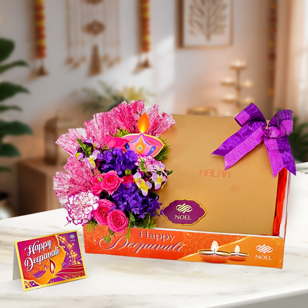 Deepavali Purple Grace Gift Hamper with traditional sweets, nuts, purple hydrangea, carnations and pink roses