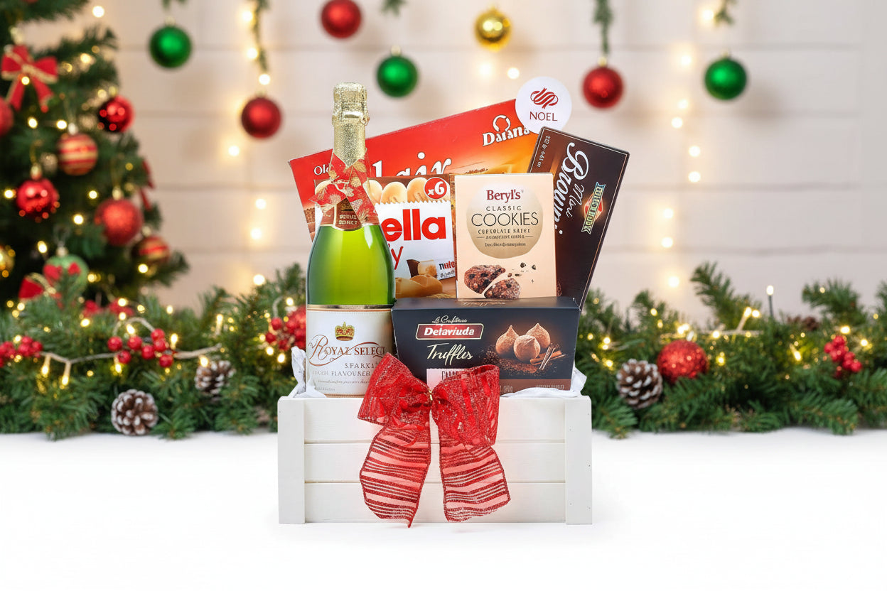 Gift basket with a bottle of champagne, cookies, and other snacks on a white background