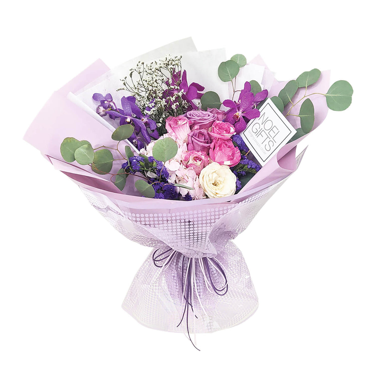 Opal Elegance Hand Bouquet with two-tone pink roses, purple orchids, pink hydrangea, white rose, eucalyptus, white caspia and dark blue statice in pastel purple wrapping.
